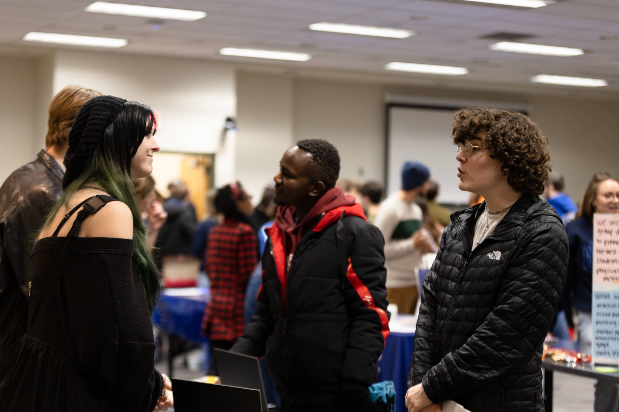 4 students smiling and talking